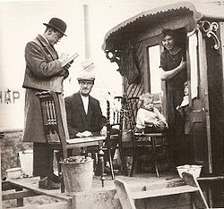 A census taker visits a family of indigenous Dutch Travellers living in a caravan in the Netherlands in 1925.