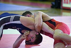 Collegiate and scholastic wrestling, the form of wrestling at the collegiate and high school levels, focuses on one wrestler's dominance and control of the other while freestyle wrestling involves a greater emphasis on explosive action by wrestlers