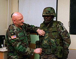 Two U.S. Army soldiers presenting the Personnel Armor System for Ground Troops body armor, then regularly issued to American infantry, in 1996
