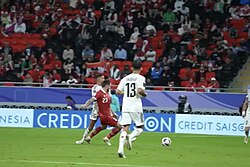 Amir Al-Ammari challenges for the ball in a 2023 AFC Asian Cup match which Iraq won 3–1 against Indonesia.