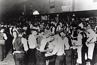 White and black postal clerks sorting mail together, US, 1890