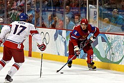 Alexander Ovechkin of the Russian men's hockey team moves the puck as Czech Republic's Filip Kuba defends against him, during the 2010 Olympics.