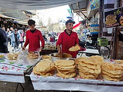 Naem bread salesman, brushing the bread with grape syrup
