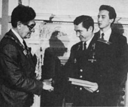 Firefighter Leonid Telyatnikov being decorated for bravery
