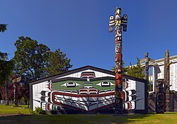 Painted house by Mungo Martin, with surrounding totem poles.