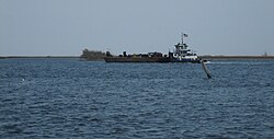 Tugboat and barge in MRGO at Shell Beach, St. Bernard Parish