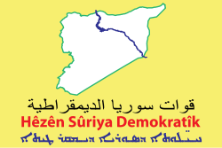 The multilingual flag of Syrian Democratic Forces expresses the polyethnic agenda of the faction in the Syrian Civil War as opposed to Arabization policies.