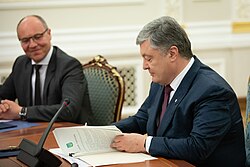 Poroshenko and Andrii Parubii signing the law "On provision of the functioning of the Ukrainian language as the State language"