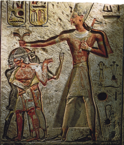 A relief of Ramesses II from Memphis showing him capturing enemies: a Nubian, a Libyan and a Syrian, c. 1250 BC. Cairo Museum.[36]