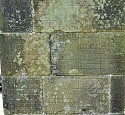 A portion of the badly eroded table inscribed on the pillar