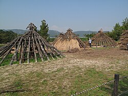 Various reconstructed umjip at various stages of completion in Amsa-dong Neolithic Site [ko]