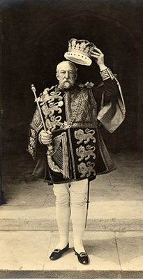 Sir William Henry Weldon, the Norroy King of Arms from 1894 until 1911, wearing the tabard and donning the crown of the King of Arms at the 1902 coronation of King Edward VII