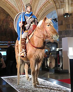 Carolingian warrior on a war horse (8th to 10th century) with lance, round shield, chainmail and spangenhelm in the Coronation Hall of the Aachen City Hall in June 2014 on the occasion of the exhibition "Charlemagne – Power, Art, Treasures"
