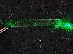 A laser bouncing down an acrylic rod, illustrating the total internal reflection of light in a multi-mode optical fiber