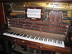 The keys of this player piano from 1885 are controlled by musical information in the center piano roll.