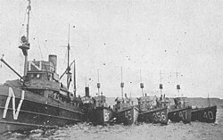 USS Eider (Minesweeper No. 17) (left) in port with submarine chasers alongside during the clearance of the North Sea Mine Barrage in 1919. The leftmost submarine chaser is either SC-254, SC-256 or SC-259 and the others are (left to right) SC-45, SC-356, SC-47, and SC-40.