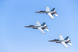 RAAF F/A-18A Hornet and F/A-18B Hornets fly in formation, 2019