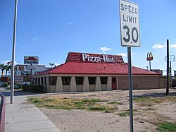 A branch of Pizza Hut in Blythe, California, with the distinctive red roof and corresponding logo