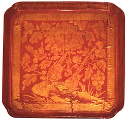 In this gold-engraved lacquerware food tray from the Song dynasty (960–1279), the two long-tailed birds represent longevity, and the peony seen at the top centre represents prosperity.