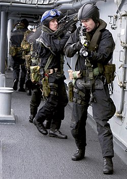 A Royal Marines team boards US Navy destroyer USS O'Bannon