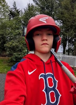 Boston Red Sox Fan wearing Red Sox Hoodie and other Baseball Merchandise