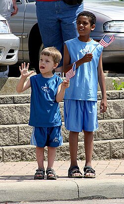 A white child and black child together at a parade in North College Hill, Ohio, US