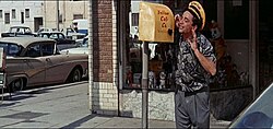 In this scene from It's a Mad, Mad, Mad, Mad World, a yellow cab driver, played by Peter Falk, contacts his dispatch through a callbox on the street. Two-way radio communication had not become a standard by the time the film was made in the early 1960s.