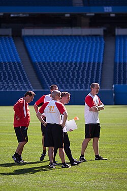 The coaching team of the Liverpool Football Club monitoring players during a training session