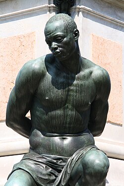 One of the four chained slaves depicted at the bottom of the 17th-century Monument of the Four Moors in Livorno, Italy.