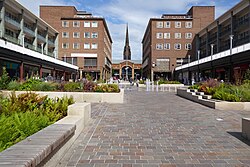 Coventry precinct with spire of ruined cathedral in the background, part of the post-war redevelopment of the city centre