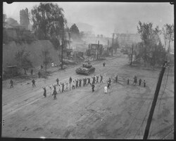 M26 Pershing tanks during the Second Battle of Seoul in September 1950. In the foreground, UN troops round up North Korean prisoners-of-war.