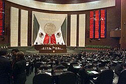 The backdrop of the Mexican Chamber of Deputies, covered with the Constitution of Mexico, Flag of Mexico and cravat. President Vicente Fox in the Mexican Chamber of Deputies.