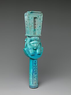 Faience sistrum with head of Hathor with bovine ears from the reign of Ptolemy I. Color is intermediate between traditional Egyptian color to colors more characteristic of Ptolemaic-era faience.[45]