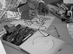 Arabic calligraphy written by a Malay Muslim in Malaysia. The calligrapher is making a rough draft.