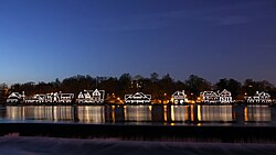 Historic Boathouse Row at night on the Schuylkill River, a symbol of the city's rich history in competitive rowing