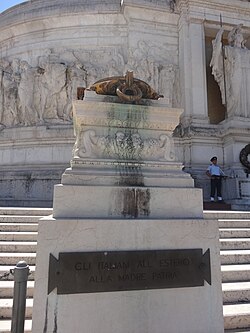One of the two braziers that burn perpetually on the sides of the tomb of the Italian Unknown Soldier at Altare della Patria in Rome. At their base there is a plaque bearing the inscription Gli italiani all'estero alla Madre Patria ("Italians abroad to the Motherland").