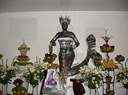 A statue of the orixá Iemanjá in Brazil, with offerings placed around it