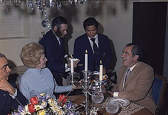 Manolo Sanchez, third from left, presents Richard Nixon with a cake at his 61st birthday party in 1974 at the San Diego home of Walter Annenberg.