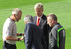 Arsène Wenger (red tie) and Mourinho (middle). Wenger was among the coaches with whom Mourinho has had confrontations.