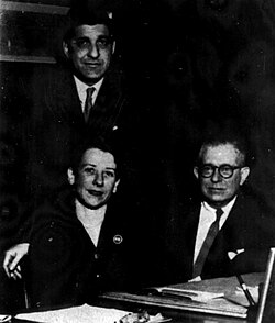 Roger Williams Straus Jr. (standing) with John C. Farrar (seated, right) and Sheila Cudahy, another business partner, c. December 1956