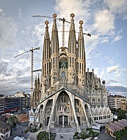 The Basilica of the Sagrada Família in Barcelona designed by Antoni Gaudí is a notable example of eclecticism in architecture. Elements of the Gothic style were merged with Art Nouveau motifs and forms found in the natural world, resulting in a structure that was distinctive and original.[1] Although it was designed during the peak of the eclectic period (1883–1926), it remains under construction today.