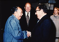 Ford and his daughter Susan watch as Henry Kissinger shakes hands with Mao Zedong, December 2, 1975