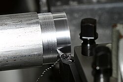 A lathe cutting material from a workpiece