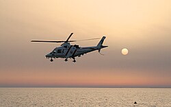 Dubai Police helicopter flying at sunset
