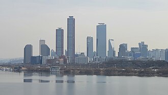 Yeouido, next to the Han river. which houses the National Assembly Proceeding Hall and many skyscrapers.
