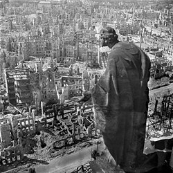 The ruins of Dresden in 1945. Facing south from the town hall (Rathaus) tower. Statue Güte (Good or Kindness) by August Schreitmüller, 1908–1910.