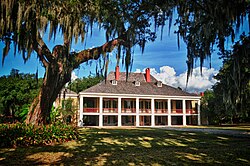 The white-columned plantation house, an "icon" of American architecture,[1] was the "popular embodiment of the plantation way of life" and the centerpiece of the very largest deep southern plantation complexes.[2] Pictured is Destrehan Plantation.