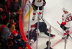 An injured skater being attended to after hitting the endboards. Because ice hockey is a full-contact sport, and involves players moving at high speeds, injuries can occur during play.