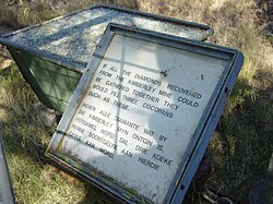 A sign next to the Big Hole, reading, "If all the diamonds recovered from the Kimberley Mine could be gathered together, they would fill three cocopans such as these."