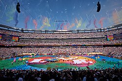 Performers hold four large banners spelling "LOVE", with Earth in place of the O, during the halftime show.